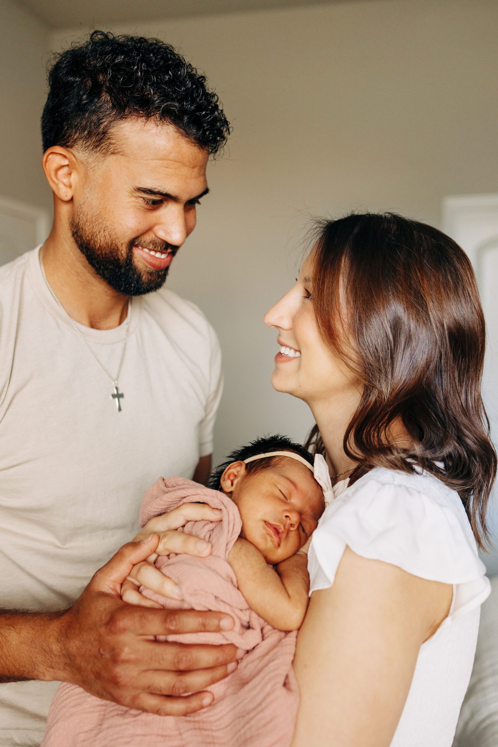parents holding newborn baby in a picture