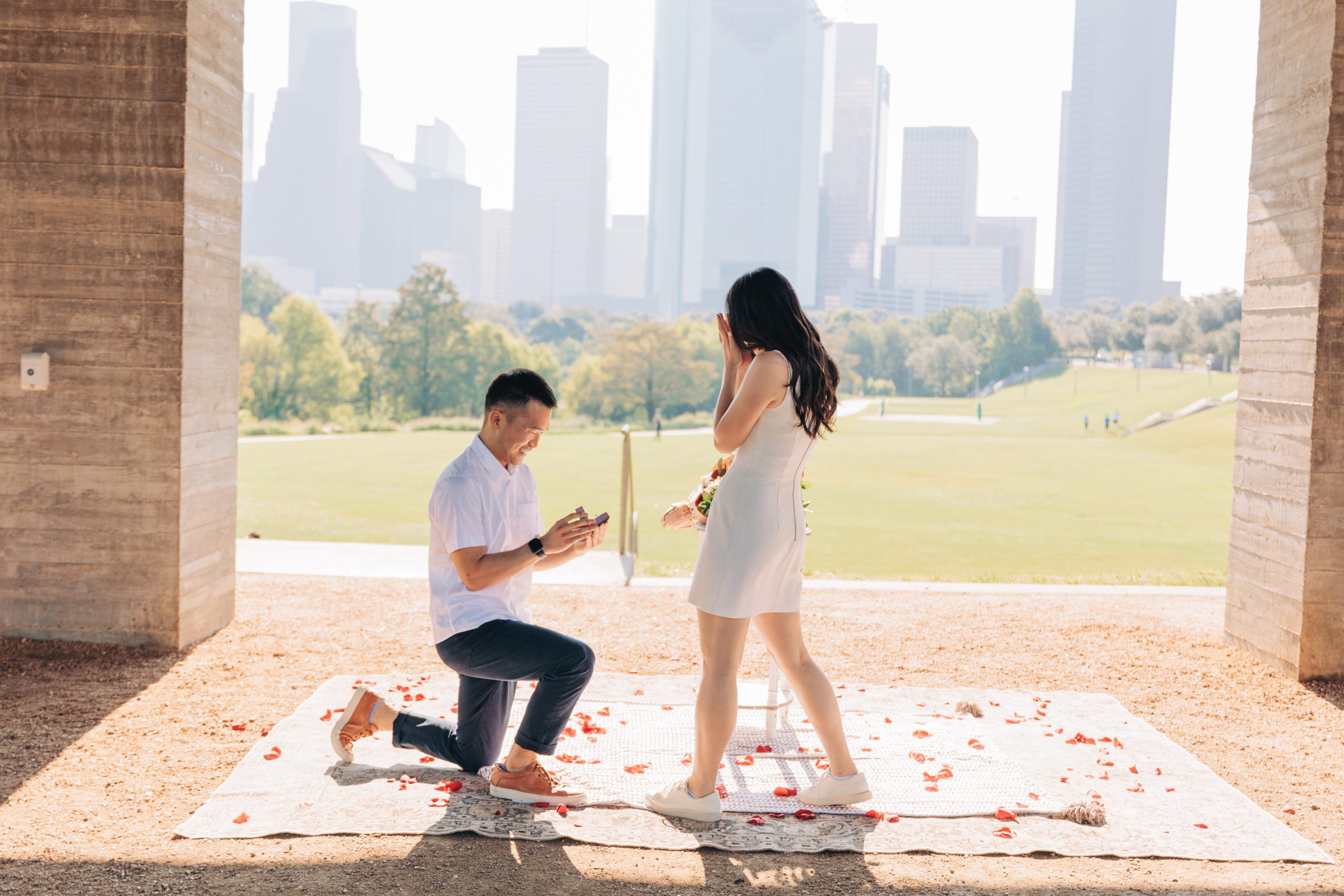 man proposing with houston skyline in the background