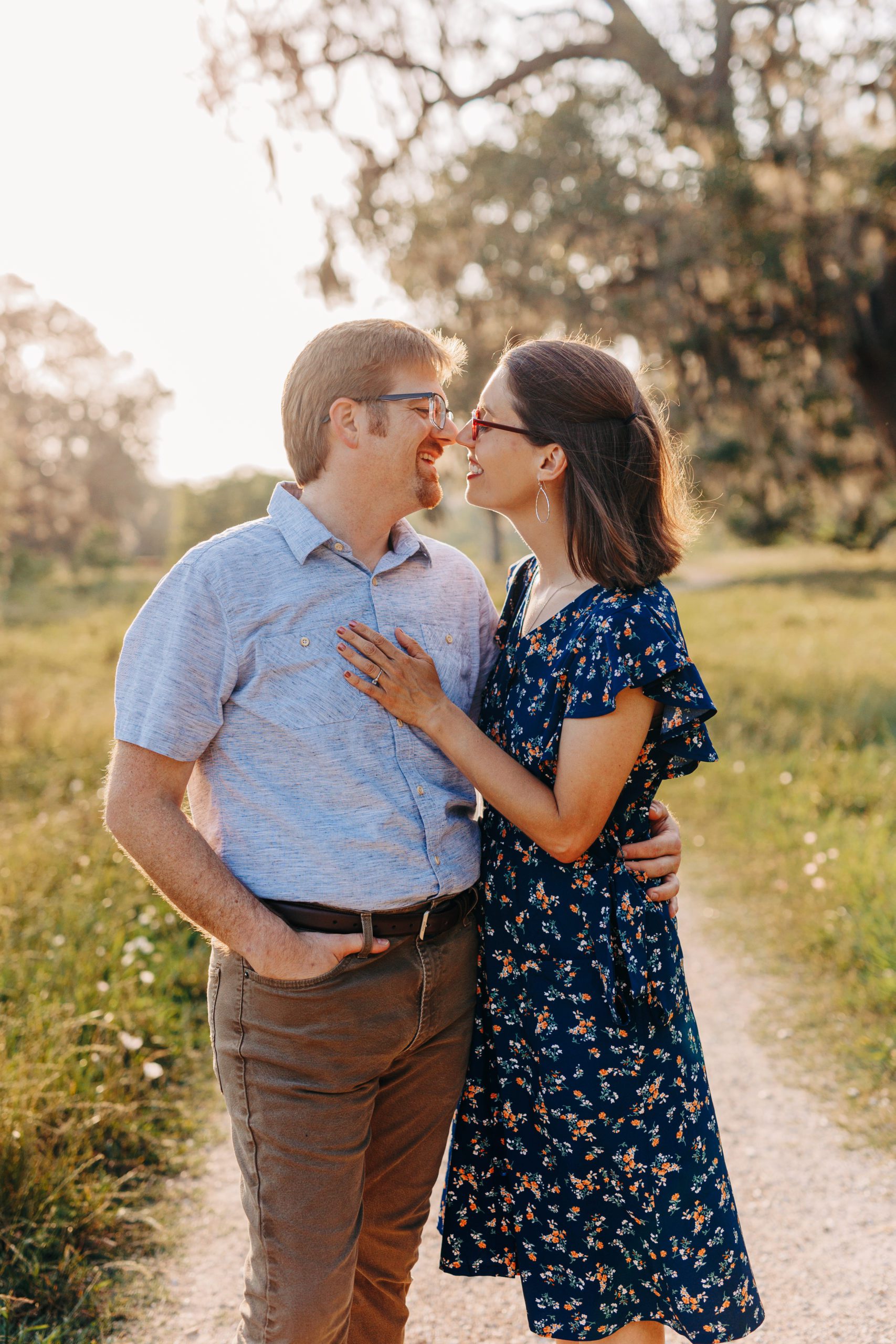 man and woman smiling into one another taken by Brazos Bend Engagement Photographer
