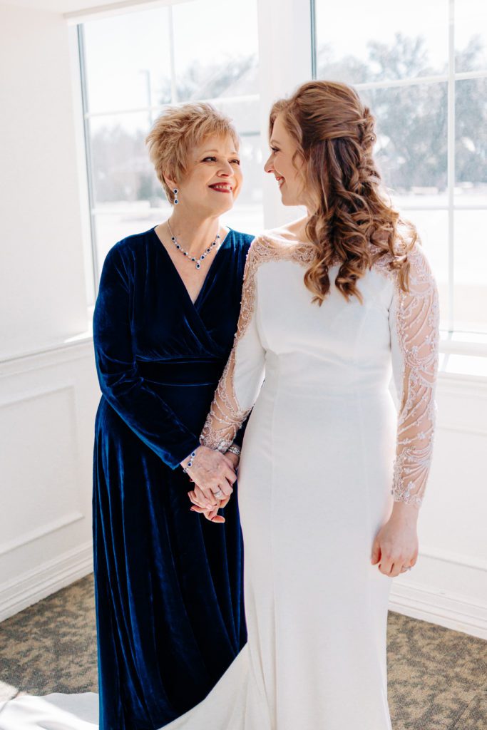Bride with her mother during a winter wedding