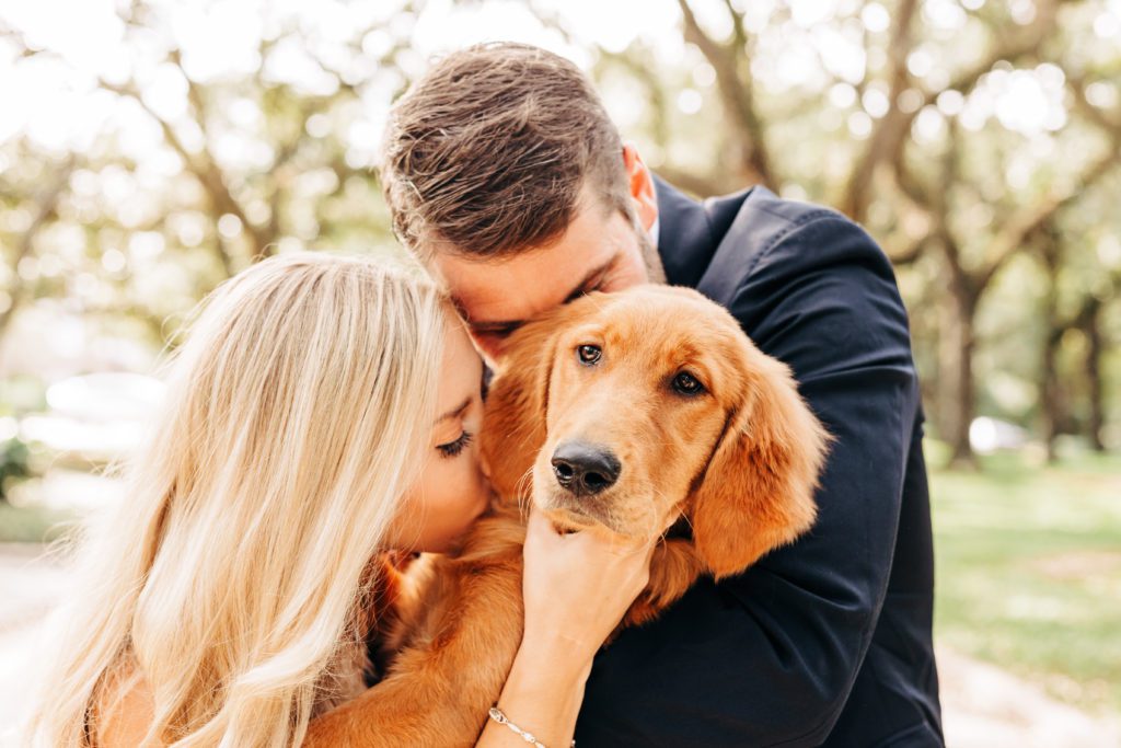 couple kissing their dog taken by Amato Photography