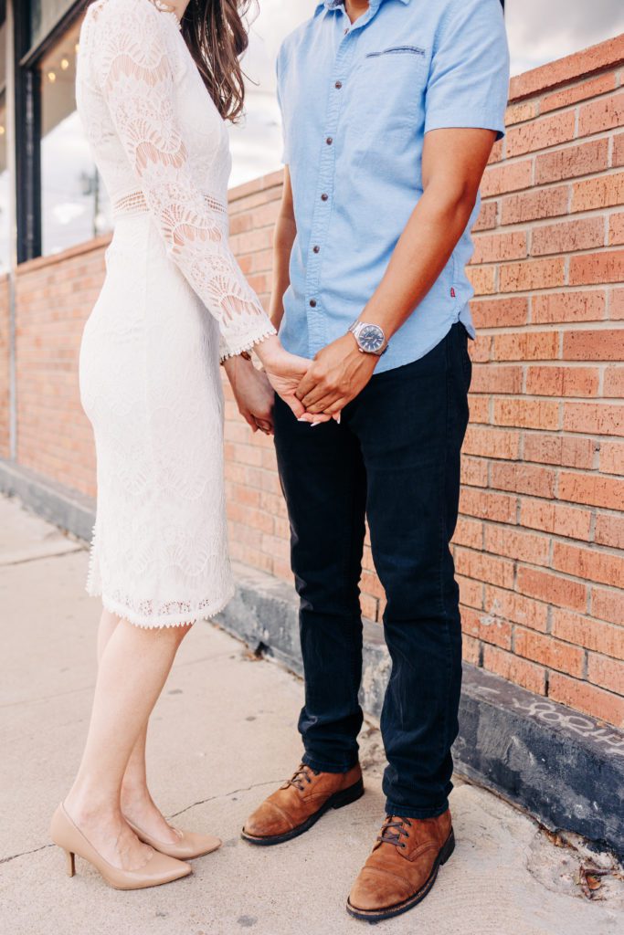 couple holding hands for an engagement photo
