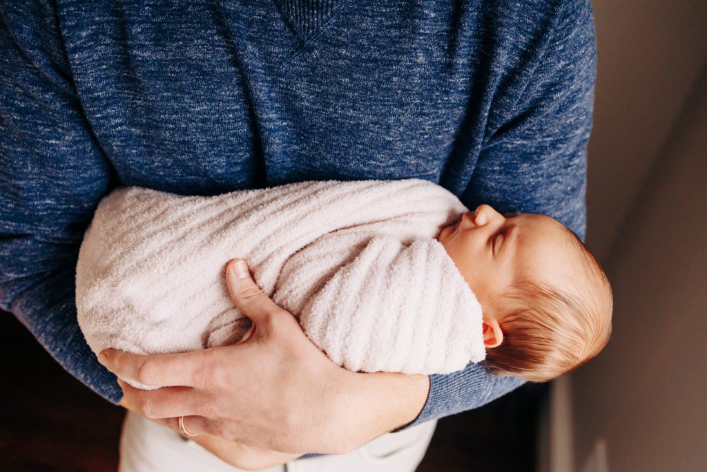 newborn baby being held by dad in houston