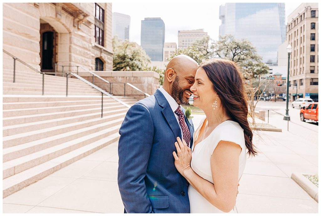 Bride and groom nuzzling taken by a houston courthouse wedding photographer