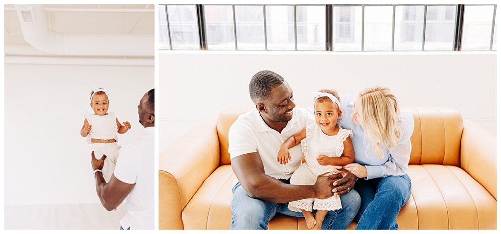 family inside a natural light studio in houston sitting on a couch and holding their baby girl