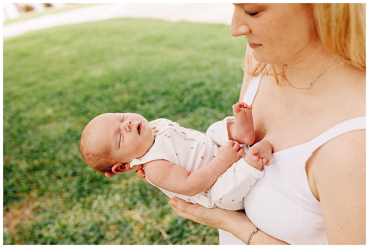 baby being held by mother during a lifestyle newborn session
